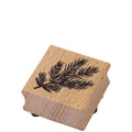 Der Stempel Tannenzweig von Artoz Papier AG ist ein quadratischer Holzstempel mit schwarzem Tannenzweig-Motiv und strukturierter Holzmaserung - ideal für Bastelarbeiten und die Herstellung einzigartiger Kunstwerke.