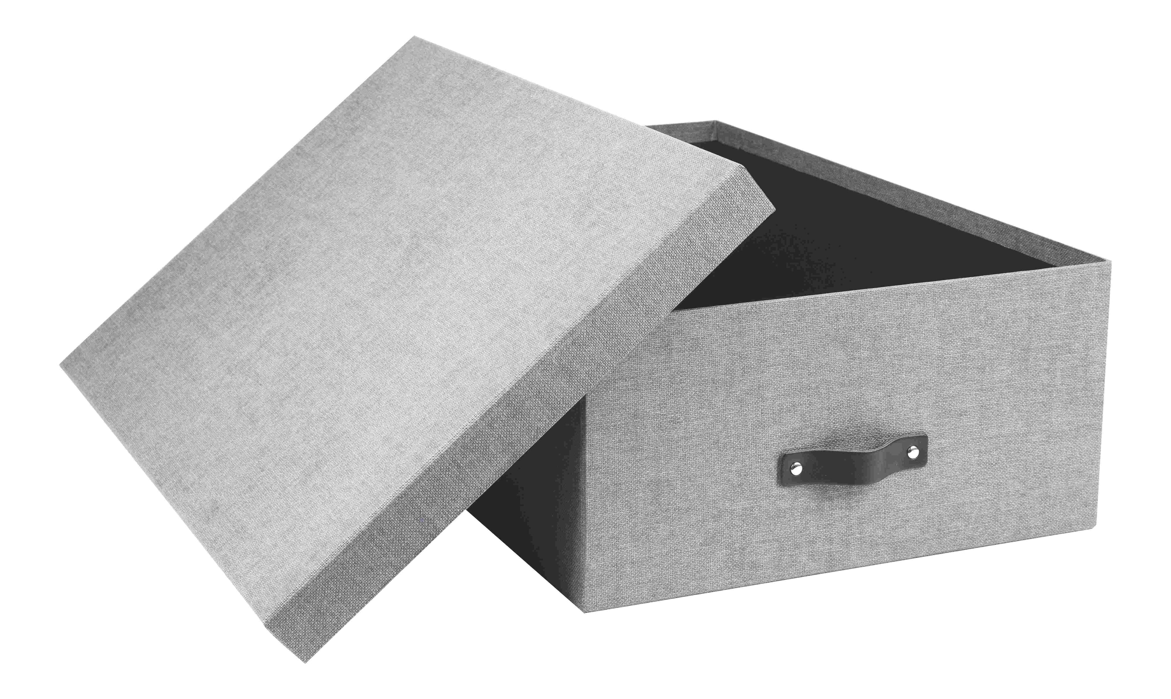 La boîte à outils Artoz Papier AG en lin gris, avec une poignée noire, est présentée partiellement ouverte et penchée sur le côté. Elle est parfaite pour organiser votre bureau à domicile avec style.