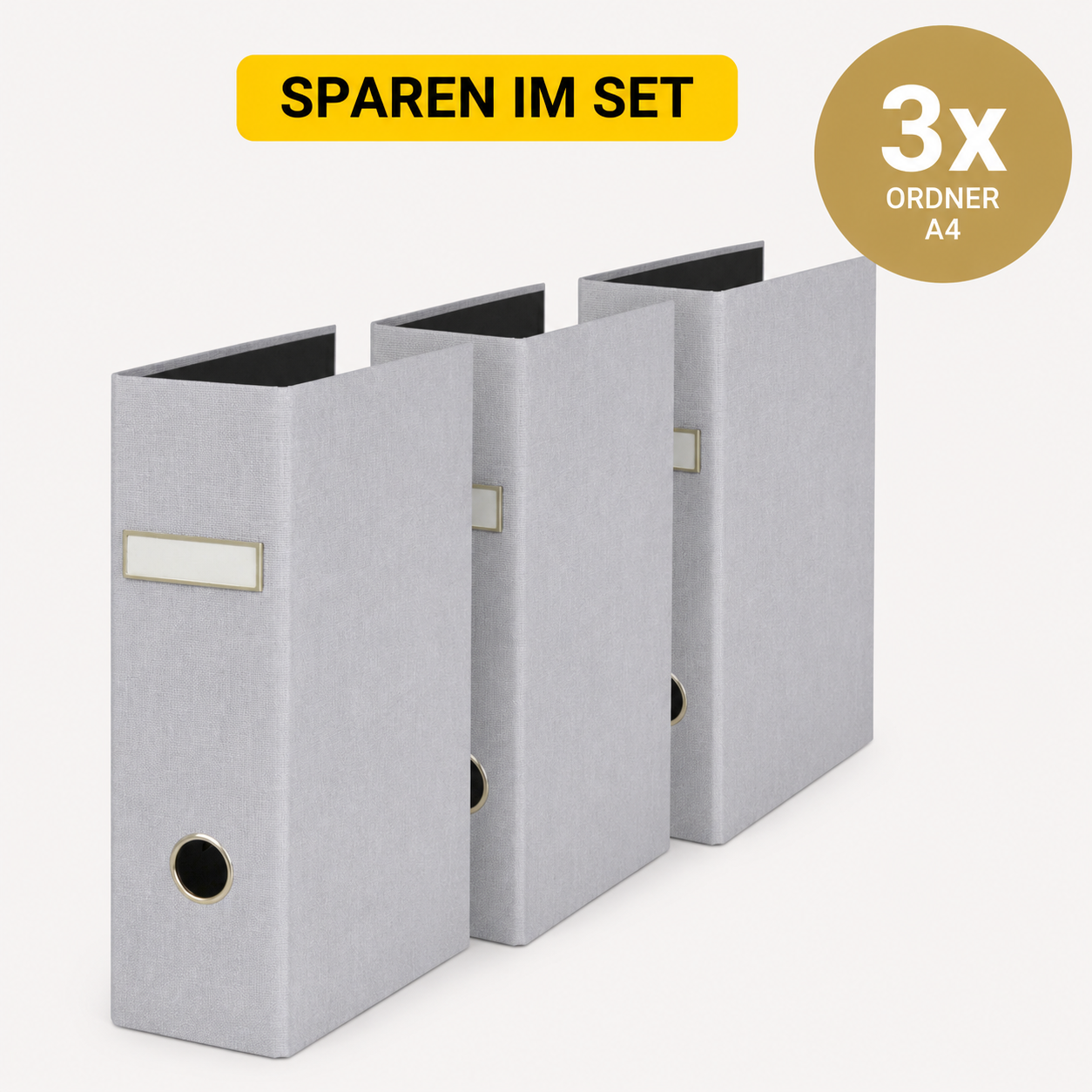 Drei graue Artoz Papier AG 3er Set Ordner A4 stehen nebeneinander. Oben steht auf einem gelben Banner "SPAREN IM SET", während auf der rechten Seite ein goldener Kreis "3x ORNDER A4-ideal für Ihre Home-Office-Ausstattung" anzeigt.