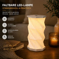 La lampe de table LED pliable Aurora d'Artoz Papier AG, dotée d'une commande tactile, d'un variateur d'intensité et d'un port USB-C, offre une lumière chaleureuse dans un design moderne. Elle est idéale pour un éclairage agréable, pratique et peu encombrant sur n'importe quel bureau.