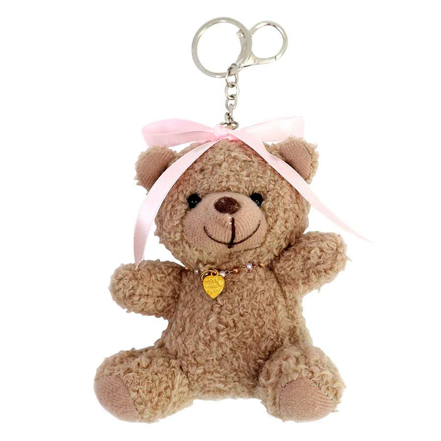 Découvrez l'adorable « porte-clés ours en peluche – ours en peluche avec nœud dans les cheveux » d’Artoz Papier AG, un ours en peluche en forme de porte-clés orné d’un nœud rose sur la tête et d’un minuscule pendentif en forme de cœur doré – une idée de cadeau idéale et pleine de tendresse.