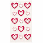 Une feuille d'Artoz 3D Sticker "Herzen" d'Artoz Papier AG comprend 15 autocollants artisanaux en forme de cœur avec des cœurs rouges ou roses à l'extérieur et des cœurs blancs plus petits à l'intérieur, soigneusement disposés sur un fond blanc.