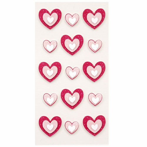 Une feuille d'Artoz 3D Sticker "Herzen" d'Artoz Papier AG comprend 15 autocollants artisanaux en forme de cœur avec des cœurs rouges ou roses à l'extérieur et des cœurs blancs plus petits à l'intérieur, soigneusement disposés sur un fond blanc.