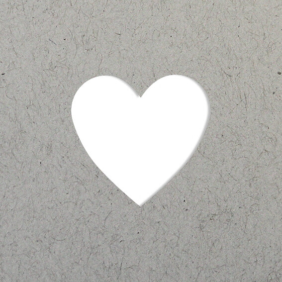 L'Artoz Papier AG Stanzer S Herz crée un cœur blanc, idéal pour les Karten gestalten ou Basteln, centré sur un fond gris texturé.
