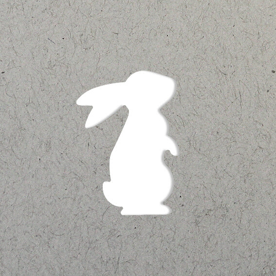 La silhouette blanche d'un lapin assis, inspirée du Stanzer S Hase d'Artoz Papier AG, est centrée sur un fond texturé gris clair.