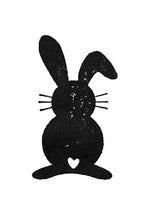 Le Stempel Osterhase d'Artoz Papier AG présente une silhouette de lapin noir avec de longues oreilles, des moustaches et un cœur découpé - idéal pour les Einladungskarten ou les Bastelarbeiten. Illustré sur fond blanc.