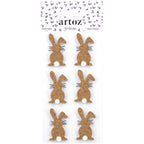 Une feuille de six silhouettes de lapin Artoz 3D Sticker "Hase Basic" avec des queues blanches et des moustaches noires, par Artoz Papier AG, avec un design suisse et un emballage en forme de cœur.