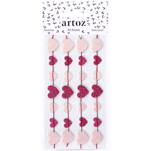 L'autocollant 3D "Herzgirlande" d'Artoz Papier AG présente des autocollants roses et rouges en forme de cœur avec des pois en rangées verticales. L'emballage met en valeur le Schweizer Design, avec un fond blanc et de petits cœurs noirs en haut.
