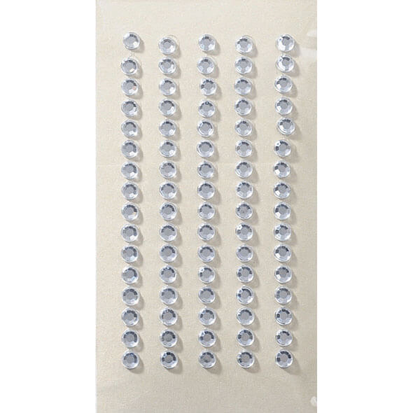 Six rangées droites d'autocollants ronds et transparents Artoz 3D Sticker "Kristall 5mm" d'Artoz Papier AG sont disposées verticalement sur un fond beige - idéal pour ajouter une touche d'élégance à tout projet créatif.