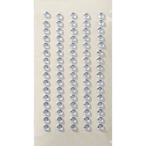 Six rangées droites d'autocollants ronds et transparents Artoz 3D Sticker "Kristall 5mm" d'Artoz Papier AG sont disposées verticalement sur un fond beige - idéal pour ajouter une touche d'élégance à tout projet créatif.