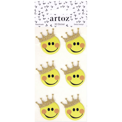 Six smileys jaunes avec des couronnes dorées scintillantes sont disposés en deux rangées sur une carte blanche étiquetée "Artoz 3D Sticker 'Smiley'" par Artoz Papier AG, une entreprise suisse de conception artisanale.