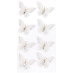 Huit délicats papillons blancs Artoz 3D Sticker "Sommervogel" d'Artoz Papier AG, fabriqués à la main avec des perles, des corps et des antennes dorés, disposés en deux rangées décalées sur un fond blanc uni, dans un élégant design suisse.