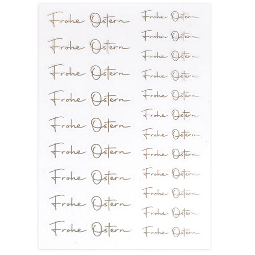 Une feuille d'Artoz Sticker Frohe Ostern transparent d'Artoz Papier AG présente l'élégant "Frohe Ostern" doré dans un quadrillage - idéal comme Osterdeko ou Sticker transparent pour vos décorations festives.