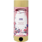 La Tischbombe ohne Feuer - Liebe d'Artoz Papier AG a un design cylindrique rose sur le thème du cœur, avec des feux d'artifice et des ballons. L'étiquette indique qu'elle est sicher, nachhaltig und wiederverwendbar (sûre, durable et réutilisable).