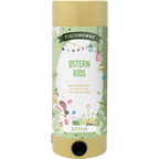 Die Tischbombe ohne Feuer - Ostern Kids von Artoz Papier AG ist ein grün-goldener Zylinder mit Osterdekoration, bunten Eiern, verspielten Häschen und kindgerechten Frühlingsmotiven, die am unteren Rand den Markennamen tragen.