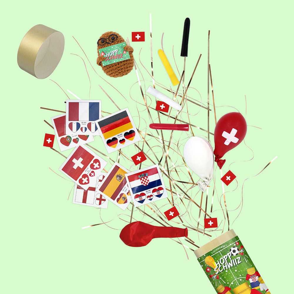 Une explosion festive de drapeaux en papier, de ballons et de décorations de fête durables, y compris des drapeaux suisses et européens, provenant de l'Artoz Papier AG Tischbombe ohne Feuer - Fussball WM Team Schweiz, décore un arrière-plan vert clair.